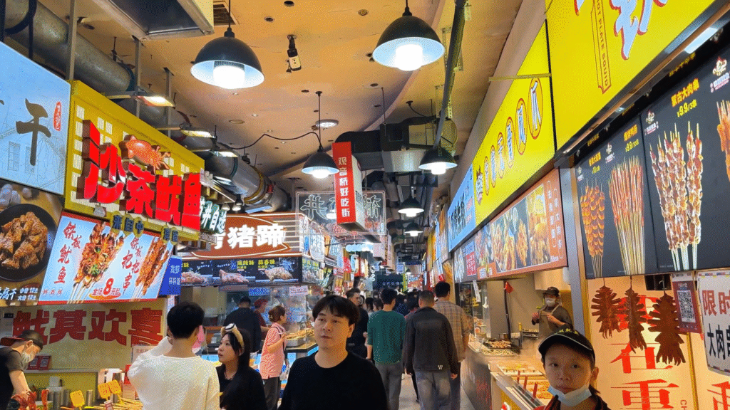 Tourist shuffling between stalls at Guānyīnqiáo Yummy Street Area A - Ultimate Chongqing Itinerary: 7 Top Attractions - Leo Trails