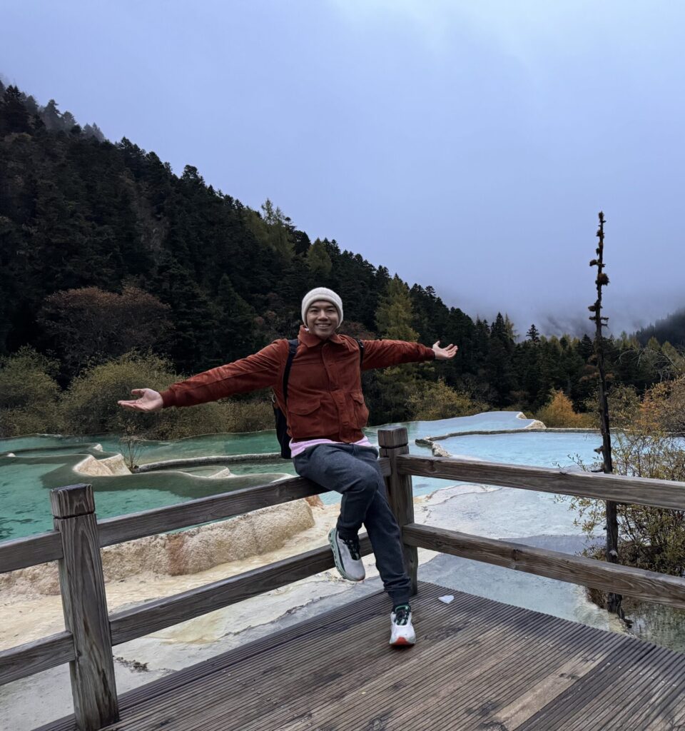 Me posing at the travertine pools - Exploring Huanglong: A Breathtaking Experience - Leo Trails