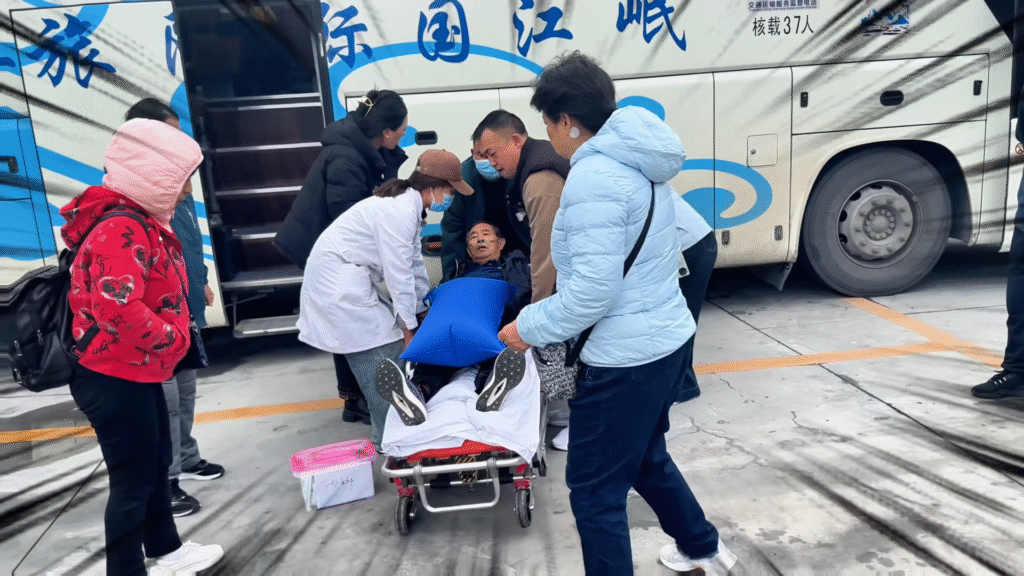 Travelers helping an elderly man - Exploring Huanglong: A Breathtaking Experience - Leo Trails