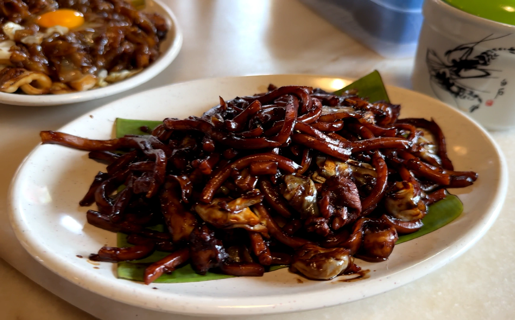 A plate of Hokkien mee on the table -Try KL Dishes That Locals Love - leo trails
