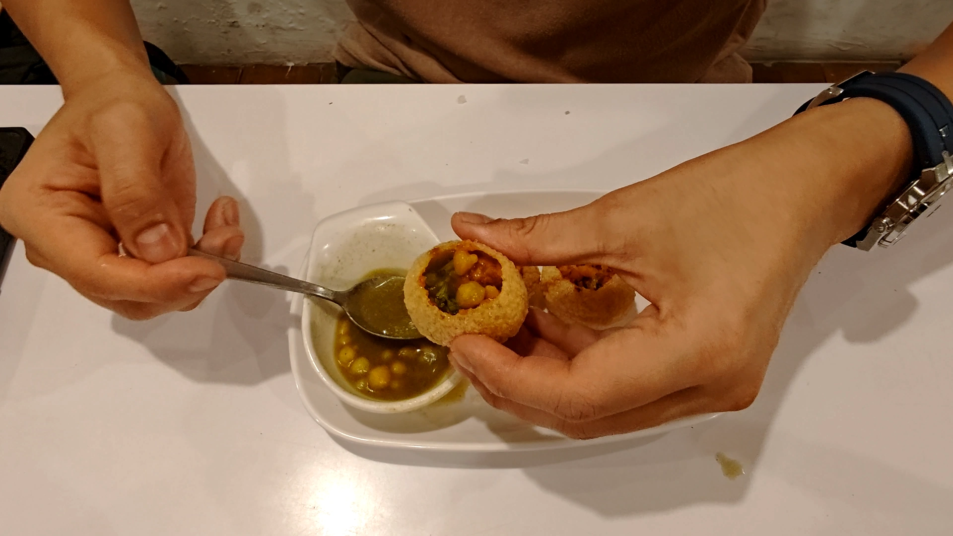 I am pouring chickpeas to my pani puri - Try KL Dishes That Locals Love - leo trails