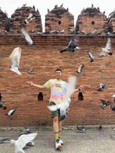 Me pose with the pigeons at Tha Phae Gate - 9 Best Experiences in Chiang Mai Worth the Trip - Leo Trails