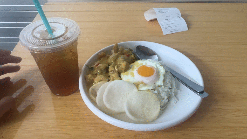 a plate of Salt egg chicken with rice and a glass of iced tea - How to Enjoy Singapore Without Breaking the Bank - Leo Trails