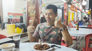 Me eating Char Kway Teow - 15 Must-Try KL Dishes That Locals Love - leo trails