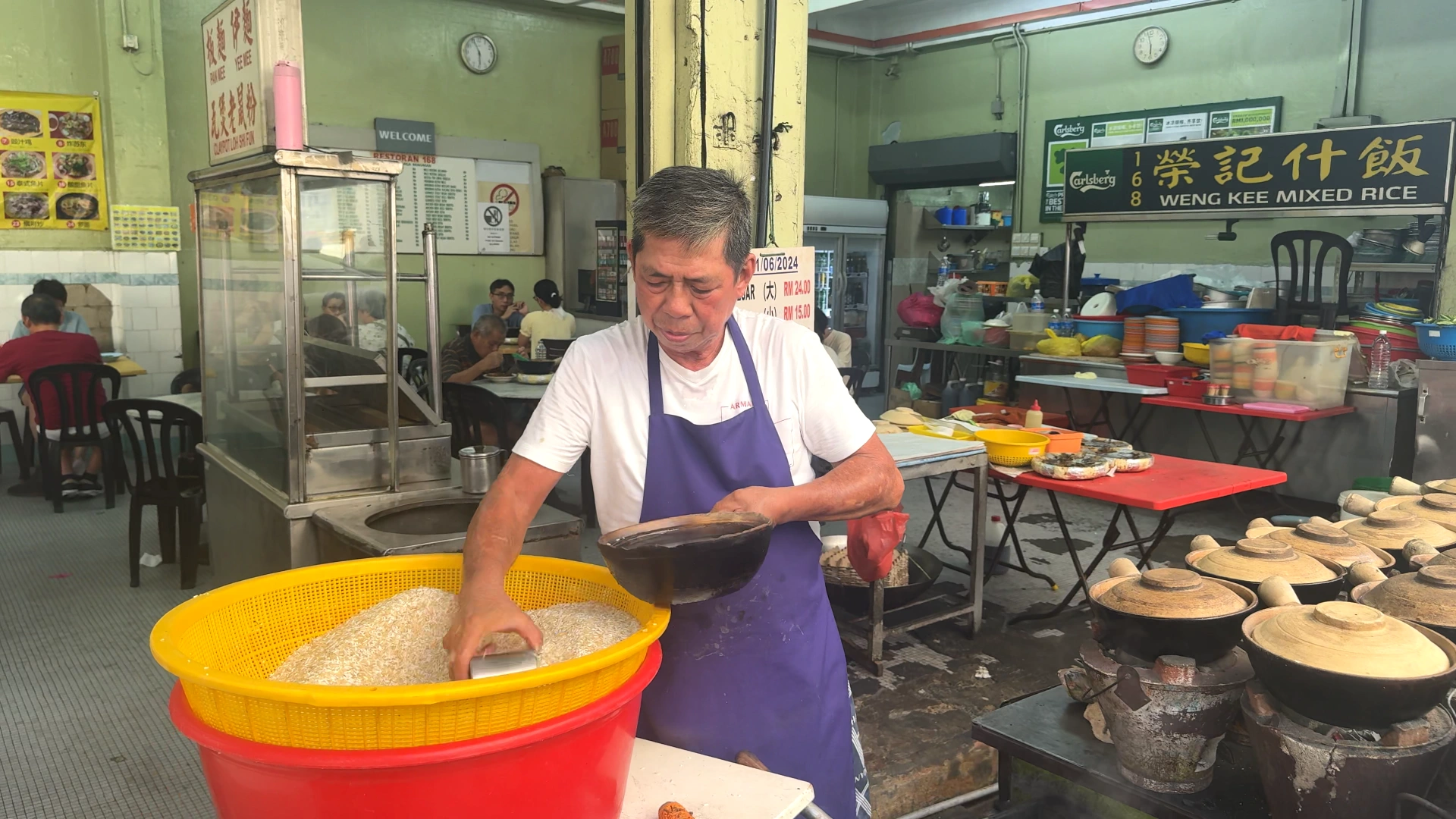 The owner is gathering some rice -Try KL Dishes That Locals Love - leo trails