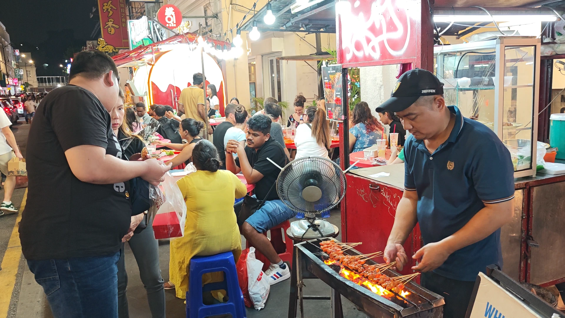 The seller is grilling the satay - Try KL Dishes That Locals Love - leo trails