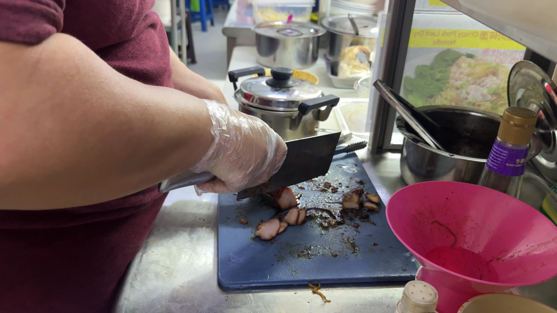 The staff chopping the charsiu - Try KL Dishes That Locals Love - leo trails