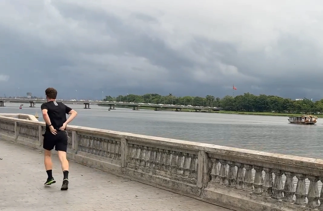 Man Jogging around Perfume River - 7 Fun Things to Do in Hue, Vietnam - Leo Trails