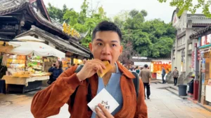 Me trying to eat Dan Hong Gao - Best Street Snacks in Jinli, Chengdu - Leotrails