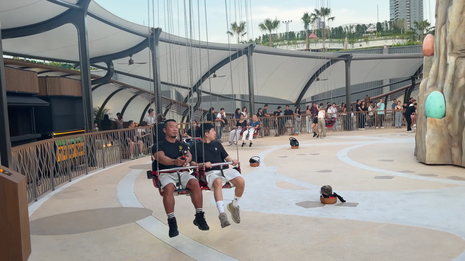 Two men sitting on the swing - The Highest Giant Swing in Bangkok: A Thrilling City View - Leotrails