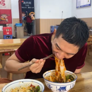 Me eating Biang Biang Noodles - 11 Must Try Experiences in Xian for First-Time Visitors - Leotrails