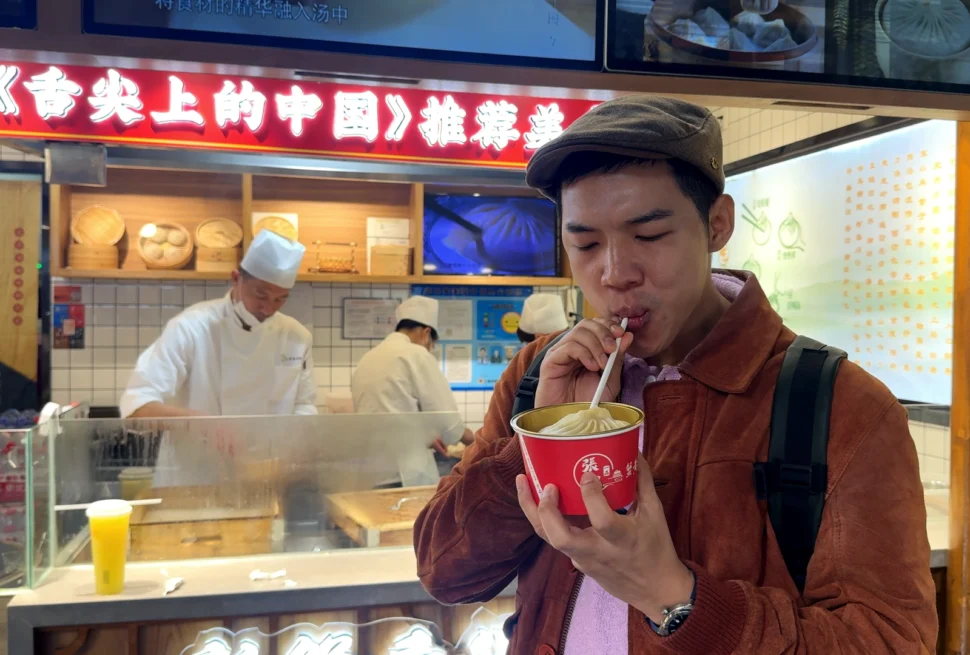 Me eating Xie Huang Tang Bao - The Ultimate Shanghai Bucket List: 9 Must-Do Experiences 🌟 - Leotrails