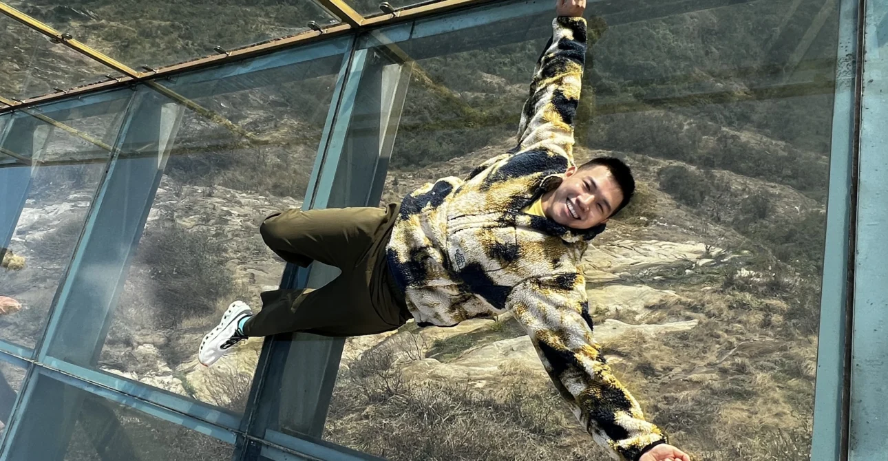 Me lying down on the glass bridge - How Much Does Sapa Travel Cost? My Day 1 Breakdown 💸- Leotrails