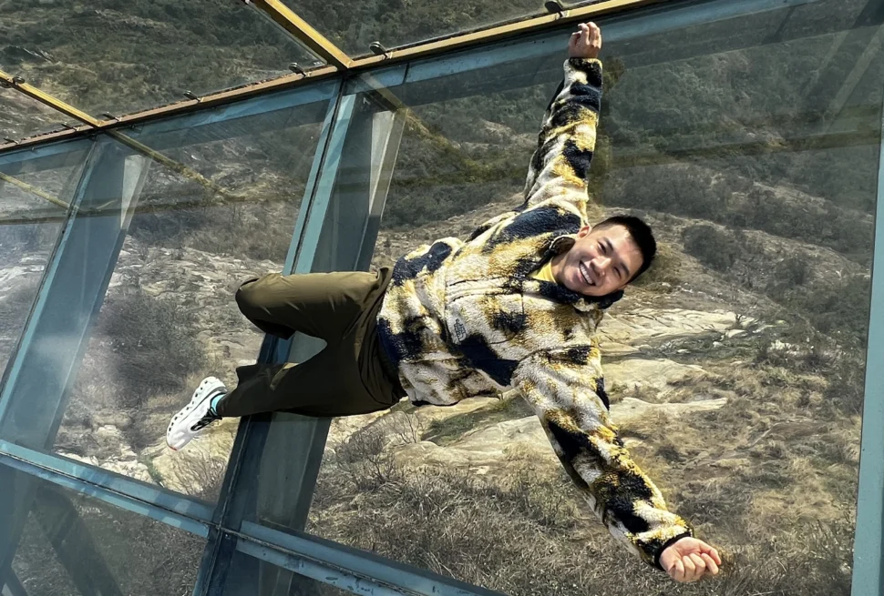 Me lying down on the glass bridge - How Much Does Sapa Travel Cost? My Day 1 Breakdown 💸- Leotrails