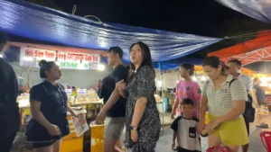 Tourist wandering the stalls - Son Tra Night Market Da Nang: Food & Things to Do - Leotrails