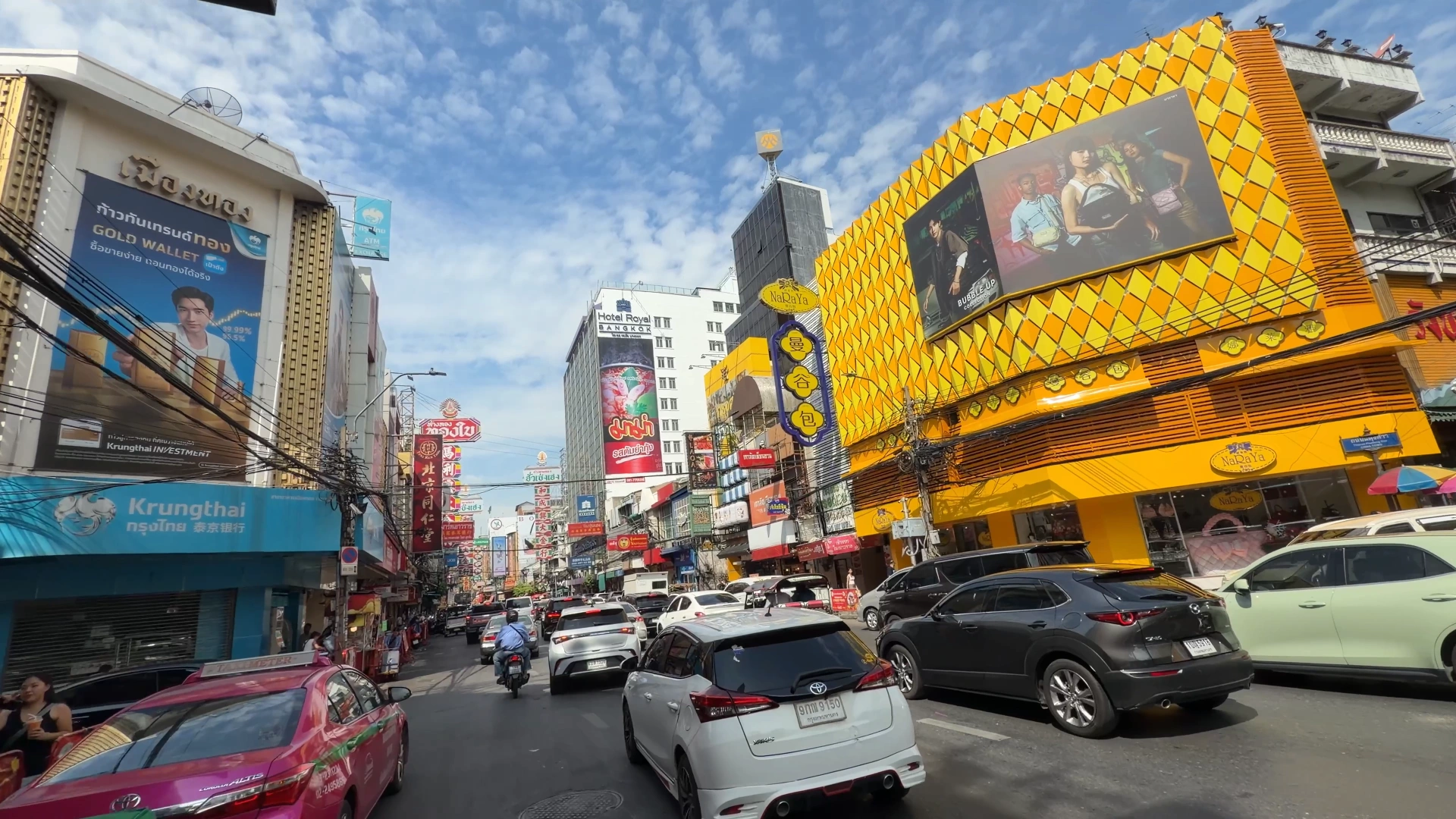Passing the striking yellow facade in Yaowarat - Song Wat Bangkok: How to Spend a Day Here 🏠 - Leotrails