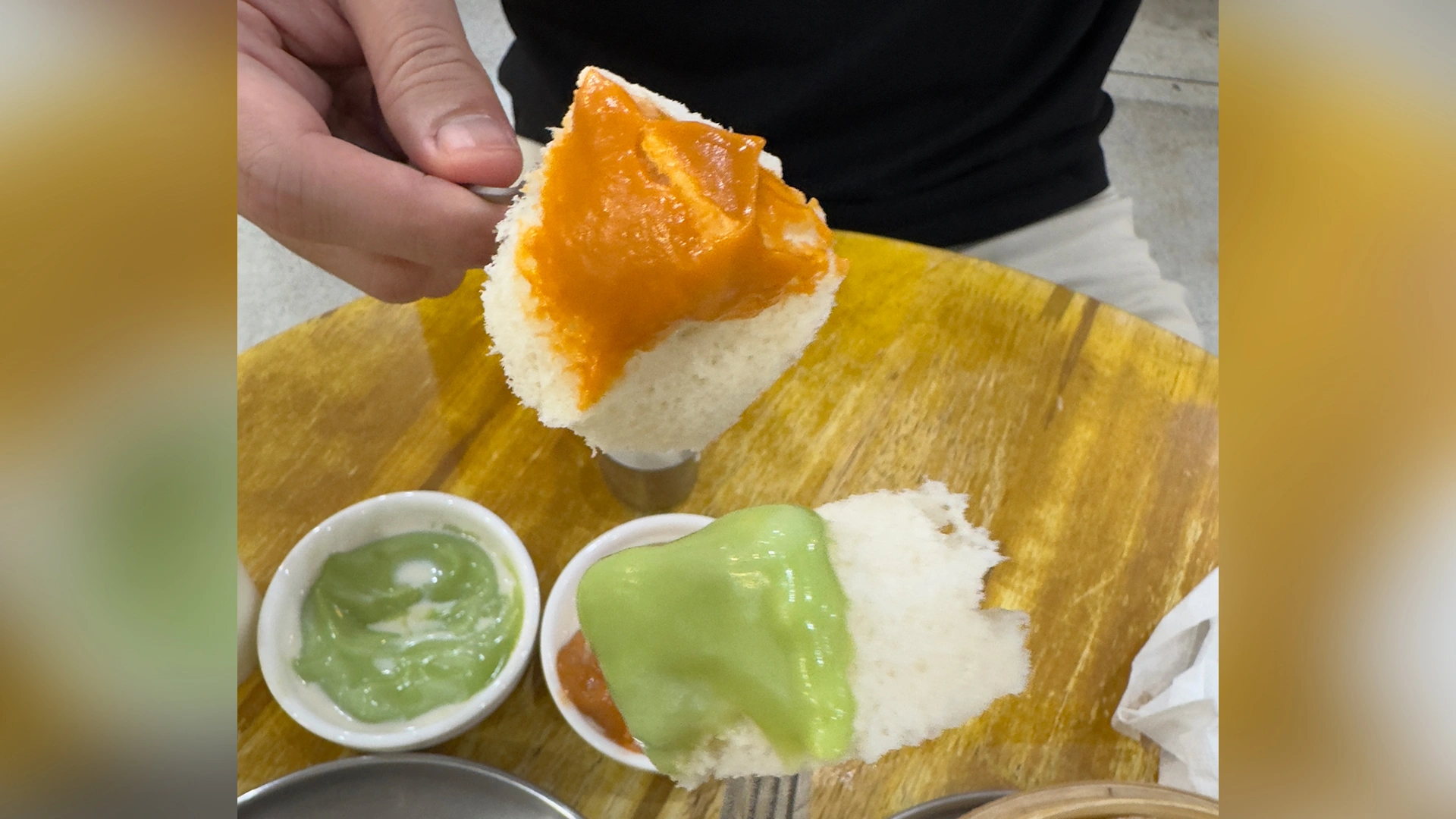 Complimentary steamed toast dipped into Thai tea and pandan custards at June Pang in Bangkok